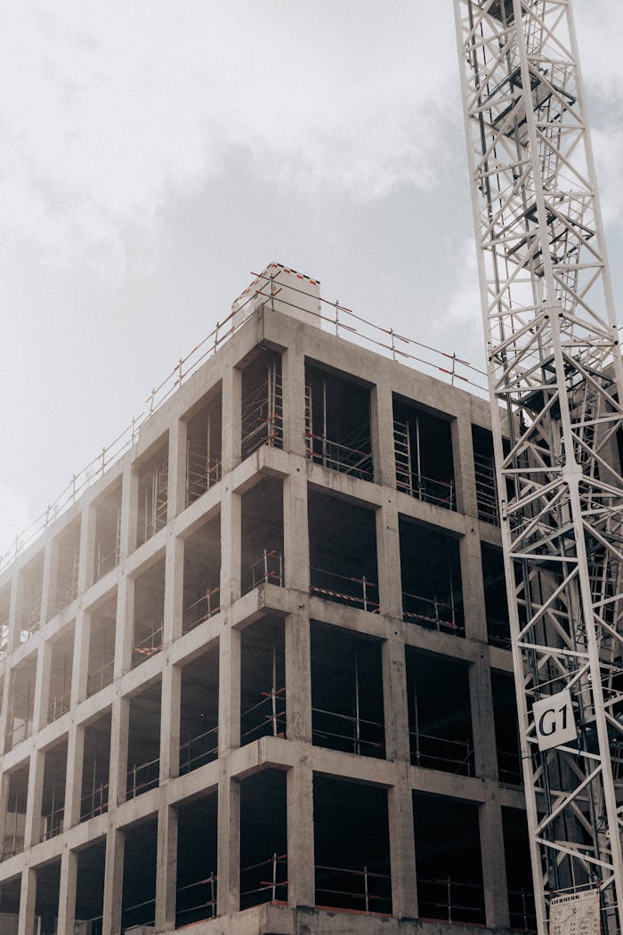 Construction site with half built building and crane in city